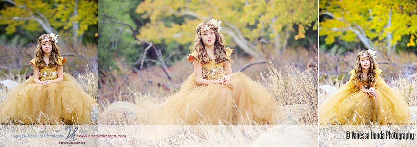 A girl in a golden dress sitting on a log